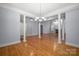 Open-concept living space with hardwood floors, decorative pillars, and a cozy atmosphere with natural light at 320 Magnolia St, Davidson, NC 28036