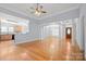 Expansive living room with hardwood floors, open layout, and seamless connection to the kitchen and foyer at 320 Magnolia St, Davidson, NC 28036