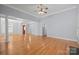 Large living space with hardwood floors, offering a versatile layout for entertaining and everyday living with natural light at 320 Magnolia St, Davidson, NC 28036