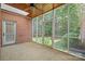 View of screened porch featuring brick wall, wood ceiling, and outdoor scenery at 320 Magnolia St, Davidson, NC 28036