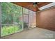 View of screened porch featuring brick wall, wood ceiling, and outdoor scenery at 320 Magnolia St, Davidson, NC 28036