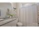 Clean and modern bathroom showcasing a sink with granite countertop, decorative touches, and shower with curtain at 336 Secretariat Dr, Iron Station, NC 28080