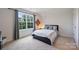 Bright bedroom featuring a large window, soft carpet, and a comfortable bed, creating a relaxing retreat at 336 Secretariat Dr, Iron Station, NC 28080