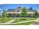 View of a community clubhouse that has beautiful landscaping and architectural details at 336 Secretariat Dr, Iron Station, NC 28080
