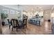 Open-concept dining area adjacent to a kitchen island and stainless steel appliances at 336 Secretariat Dr, Iron Station, NC 28080