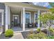 Inviting front porch with a seating area and lovely landscaping at 336 Secretariat Dr, Iron Station, NC 28080