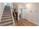 Bright hallway featuring hardwood floors, staircase, and access to other rooms, offering a warm and inviting entry at 336 Secretariat Dr, Iron Station, NC 28080