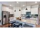 Modern kitchen boasts stainless steel appliances, granite countertops, and a breakfast bar with pendant lighting at 336 Secretariat Dr, Iron Station, NC 28080