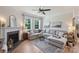 Comfortable living room with a fireplace, large windows, and hardwood flooring at 336 Secretariat Dr, Iron Station, NC 28080