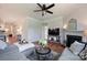 Bright living room featuring a modern ceiling fan, fireplace, and seamless transitions to other living spaces at 336 Secretariat Dr, Iron Station, NC 28080