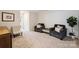 Cozy sitting room boasts neutral carpet, comfortable seating, and ample space for relaxation and entertaining at 336 Secretariat Dr, Iron Station, NC 28080