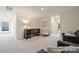 Spacious sitting room with neutral carpet, a decorative cabinet, and comfortable seating, ideal for relaxation at 336 Secretariat Dr, Iron Station, NC 28080