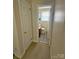 Hallway view into a compact bathroom featuring wood-look flooring, a toilet, and a single sink vanity at 3412 1St Avenue Nw Cir, Hickory, NC 28601
