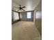 Bedroom showcases wood paneling, carpet floors, a ceiling fan, and a window for bright, natural light at 3412 1St Avenue Nw Cir, Hickory, NC 28601