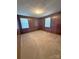 Bedroom with wood paneled walls, carpeted flooring, and natural light at 3412 1St Avenue Nw Cir, Hickory, NC 28601