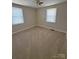 Bright bedroom with neutral carpet, ceiling fan, and windows with blinds at 3412 1St Avenue Nw Cir, Hickory, NC 28601