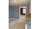Quaint kitchen with vertical striped wallpaper, a wooden countertop, and an entrance to another room at 3412 1St Avenue Nw Cir, Hickory, NC 28601