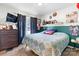 Cozy bedroom with eclectic decor, a bed with quilt, dark wood accents, and a view at 431 Forest Dr, Maiden, NC 28650