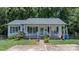 Inviting one-story house with rocking chairs, American flag and cheerful landscaping at 431 Forest Dr, Maiden, NC 28650