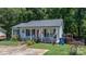 Charming single-story home with a welcoming front porch, lovely landscaping, and a gray roof at 431 Forest Dr, Maiden, NC 28650