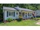 Charming home with a welcoming front porch, lovely landscaping, nice windows, and patriotic decor at 431 Forest Dr, Maiden, NC 28650