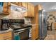This kitchen features a stainless steel refrigerator and oven, plus wooden cabinets for storage at 431 Forest Dr, Maiden, NC 28650