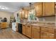 Kitchen with wood cabinets, stainless steel sink and black dishwasher with a window view at 431 Forest Dr, Maiden, NC 28650