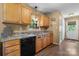This kitchen features wood cabinets, laminate countertops and stainless steel sink with a window view at 431 Forest Dr, Maiden, NC 28650