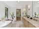 Bright bathroom featuring dual vanities, a soaking tub, and a view into the main bedroom at 440 Bridlewood Dr, Gold Hill, NC 28071