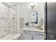 Modern bathroom features marble countertops, a shower with marble subway tile, and gold fixtures at 440 Bridlewood Dr, Gold Hill, NC 28071
