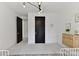 Light-filled ' bedroom with two single beds and views into the hallway through a black paneled door at 440 Bridlewood Dr, Gold Hill, NC 28071
