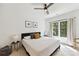 Cozy bedroom featuring a ceiling fan, neutral walls, a comfortable bed, and bright windows overlooking the outdoors at 440 Bridlewood Dr, Gold Hill, NC 28071