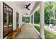 Inviting covered porch with ceiling fans, bench, and views of the landscaped yard at 440 Bridlewood Dr, Gold Hill, NC 28071