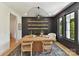 Modern dining room with black accent wall, ample natural light, and unique light fixture at 440 Bridlewood Dr, Gold Hill, NC 28071