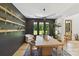 Modern dining room featuring a wood table, floating shelves with plants, and a view of the backyard at 440 Bridlewood Dr, Gold Hill, NC 28071