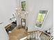 High angle view of entryway with soaring ceilings, modern chandelier, and staircase with wood and metal railing at 440 Bridlewood Dr, Gold Hill, NC 28071