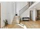 Bright entryway with light hardwood floors, black console table, and staircase with modern metal railing at 440 Bridlewood Dr, Gold Hill, NC 28071