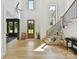 Light-filled foyer with staircase, hardwood floors, and stylish decor at 440 Bridlewood Dr, Gold Hill, NC 28071