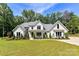Stunning white brick home with lush landscaping and inviting front porch at 440 Bridlewood Dr, Gold Hill, NC 28071
