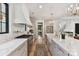 Modern kitchen with stainless steel appliances, a farmhouse sink, stone countertops, and hardwood floors at 440 Bridlewood Dr, Gold Hill, NC 28071