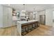 Elegant kitchen with a marble island, stainless steel appliances, pendant lights, and hardwood floors at 440 Bridlewood Dr, Gold Hill, NC 28071
