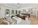 Open-concept living room with a kitchen, leather couch, lots of natural light, and hardwood floors at 440 Bridlewood Dr, Gold Hill, NC 28071