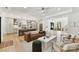 Spacious living room featuring a kitchen, leather couch, fireplace, hardwood floors, and natural light at 440 Bridlewood Dr, Gold Hill, NC 28071