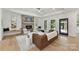 Bright living room with a fireplace, leather couch, wood floors, and black-framed windows at 440 Bridlewood Dr, Gold Hill, NC 28071