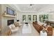 Bright open floor plan features a living room with fireplace, modern furniture, and an eat-in kitchen at 440 Bridlewood Dr, Gold Hill, NC 28071