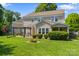 A well maintained backyard with a fire pit and seating area and lush green grass at 4408 Overbecks Ln, Waxhaw, NC 28173