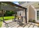 Outdoor patio with pergola, rocking chairs, and hammock extending from the house at 4408 Overbecks Ln, Waxhaw, NC 28173