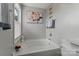 Bright bathroom with white tub, decorative art, and ample natural light from the window at 4408 Overbecks Ln, Waxhaw, NC 28173