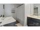 Bathroom featuring dual vanities, modern fixtures, and neutral tones with a patterned shower curtain at 4408 Overbecks Ln, Waxhaw, NC 28173