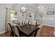 A dining room with dark wood floors, table, and decor at 4408 Overbecks Ln, Waxhaw, NC 28173